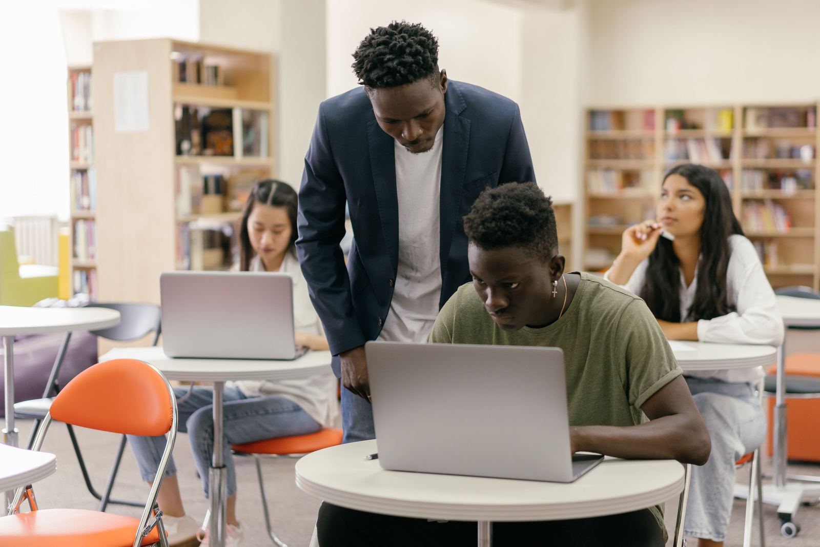 A teacher guiding a student through a coding lesson